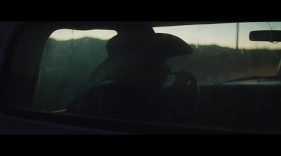 a person sitting in a car in the rain