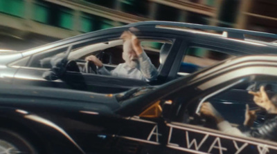 a man driving a car with a dog in the passenger seat