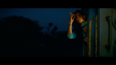 a woman smoking a cigarette in the dark