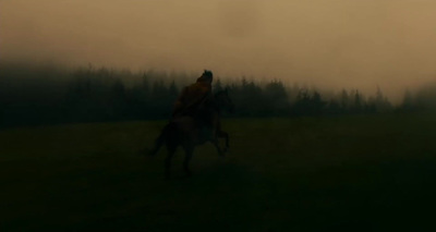 a blurry photo of a person riding a horse