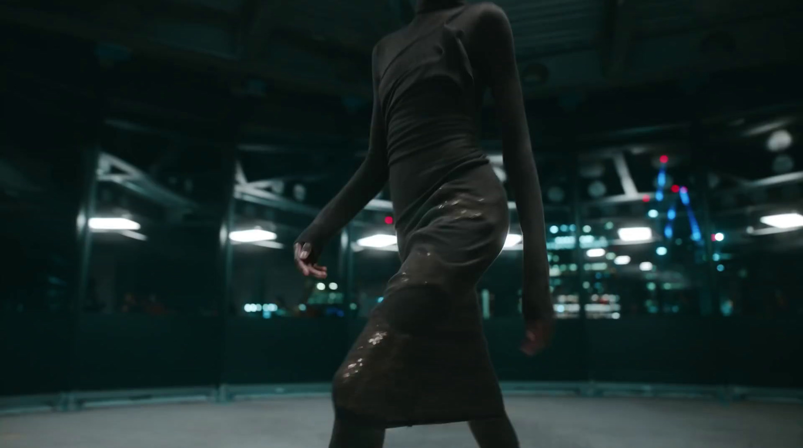 a woman is standing on a skateboard in a dark room