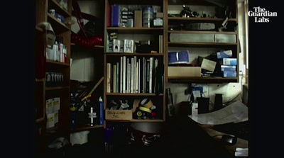 a bookshelf filled with lots of books in a room