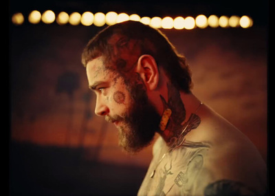 a man with a beard and tattoos on his face