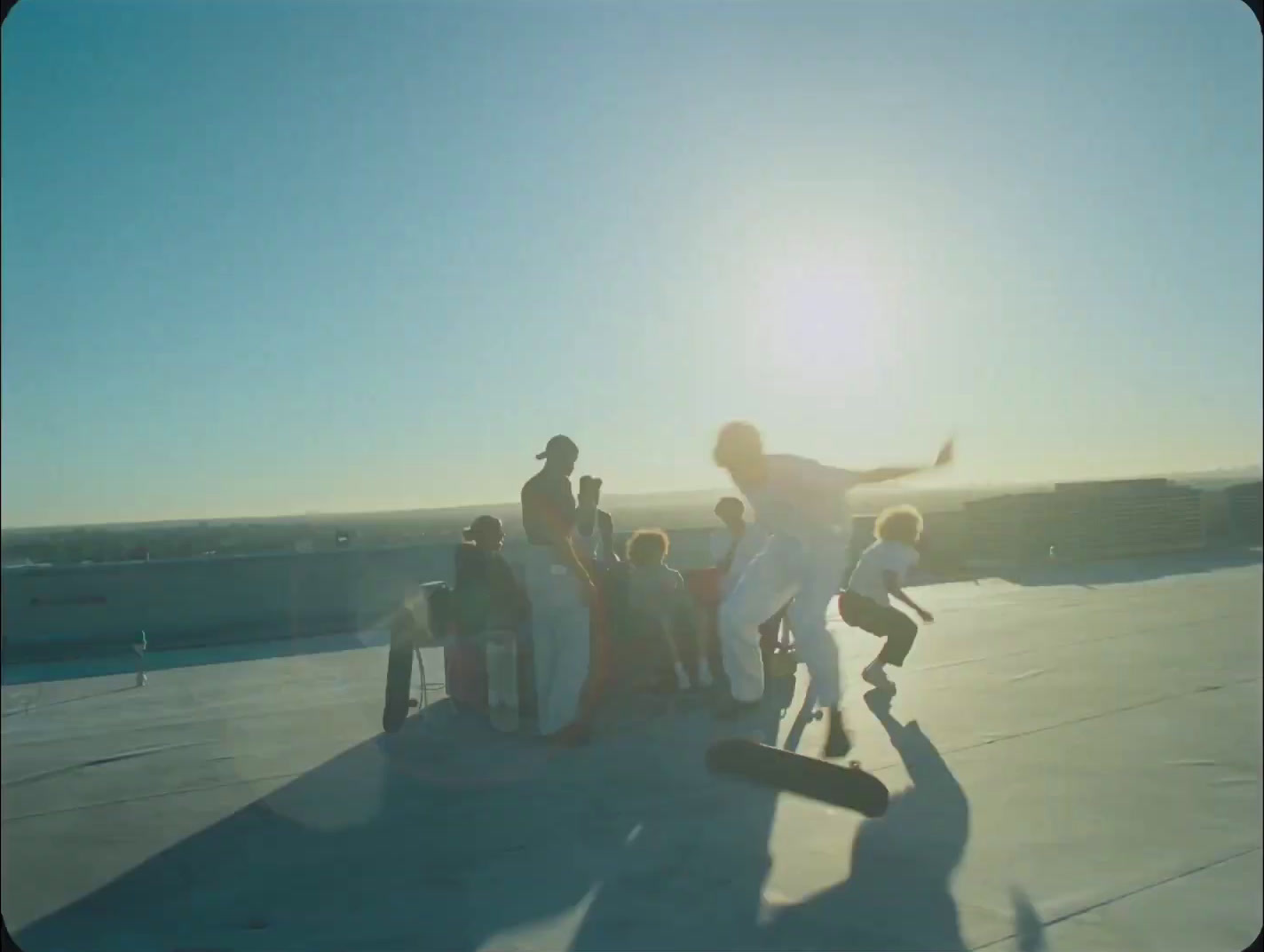 a group of people standing around a skateboard