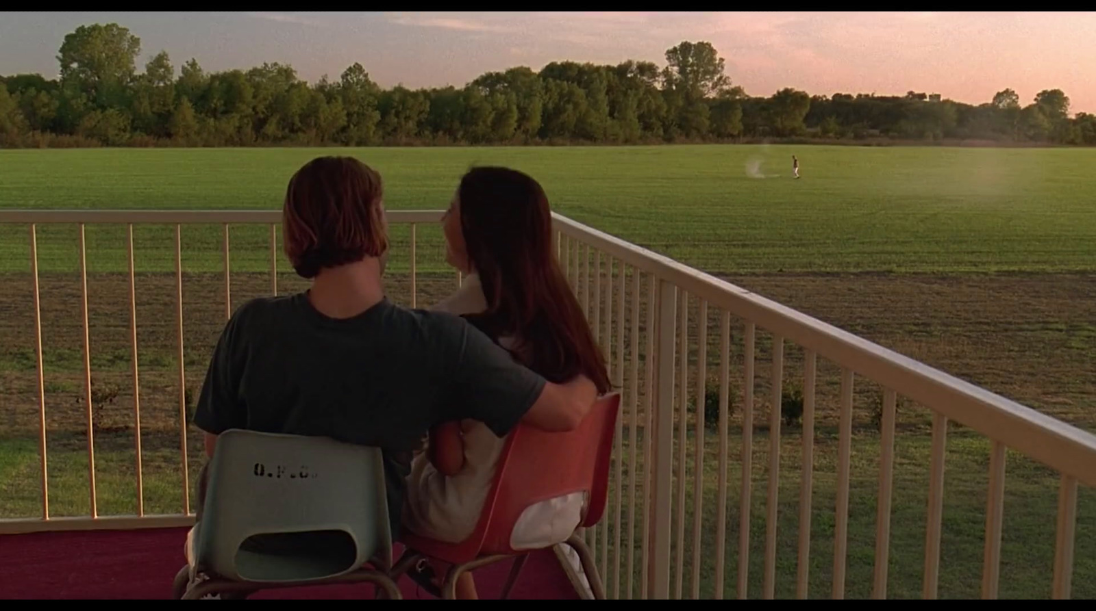 a man and a woman sitting on a balcony