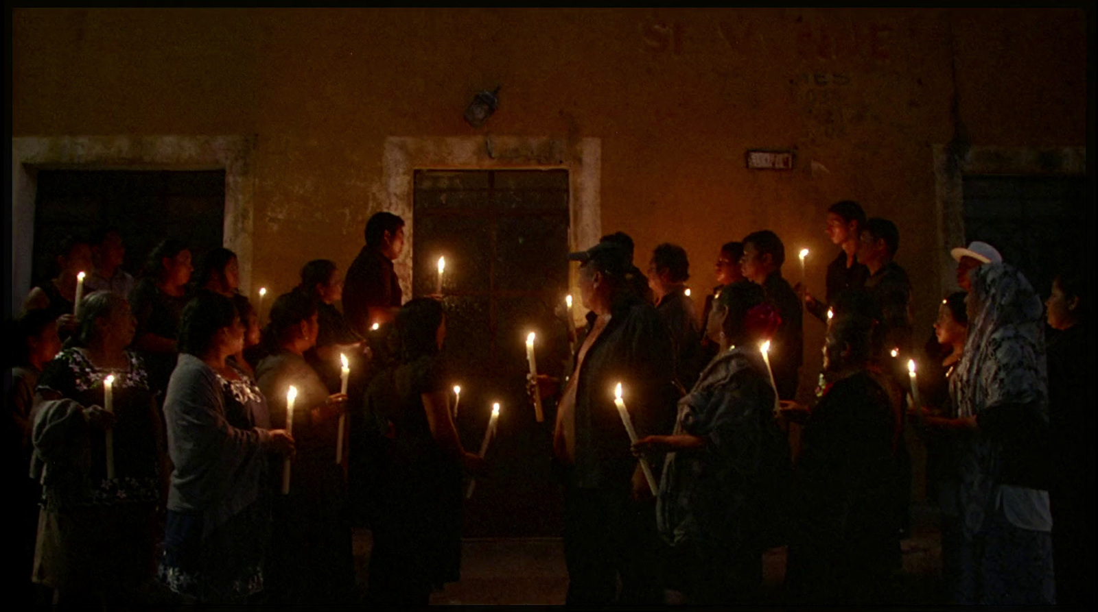 a group of people holding candles in their hands