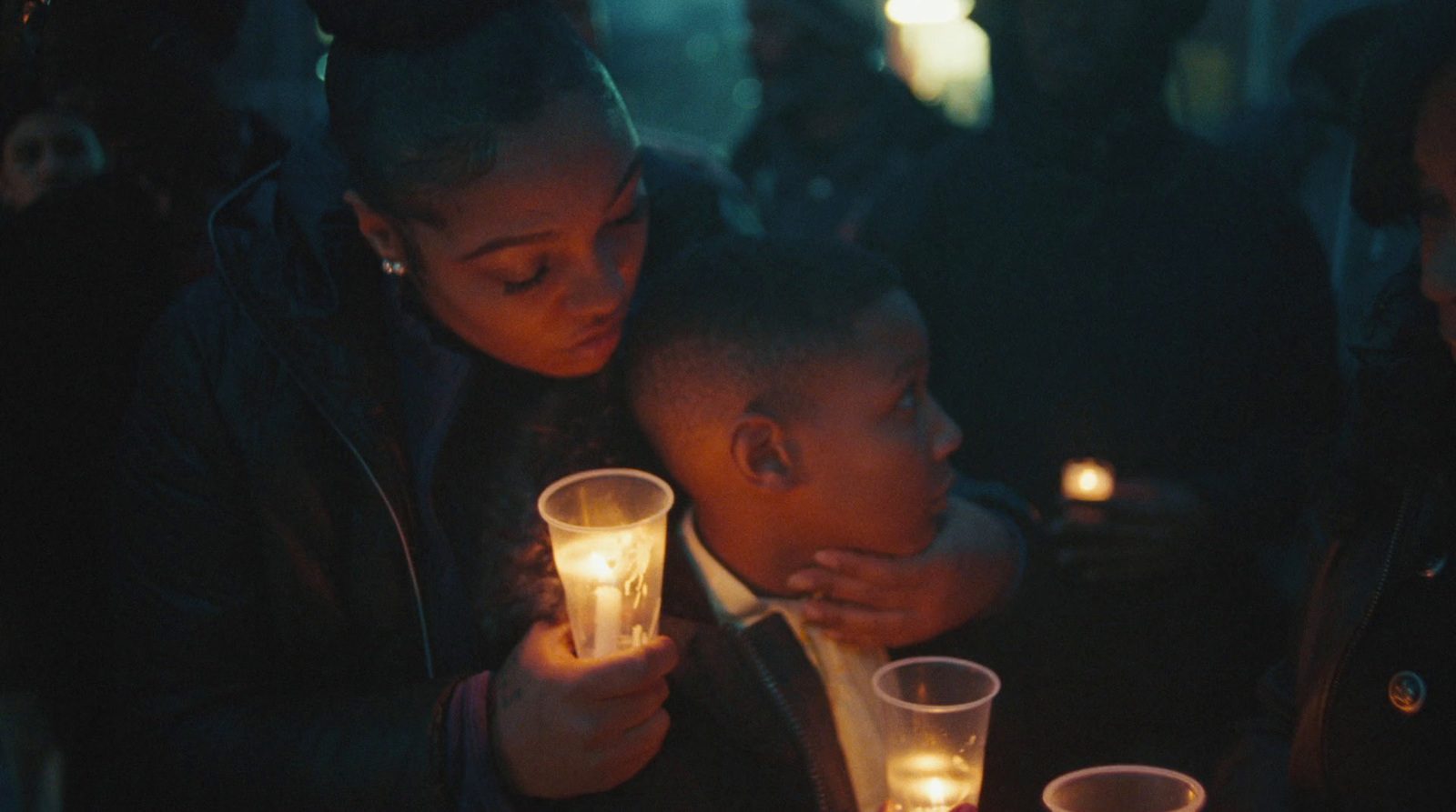 a couple of people sitting at a table with candles