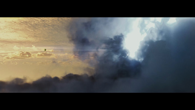 a plane flying through a cloud filled sky