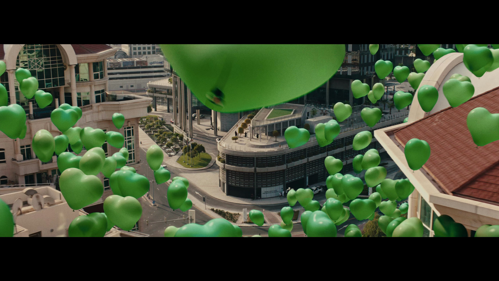 a bunch of green balloons floating in the air