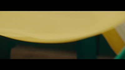 a close up of a yellow chair with a blurry background