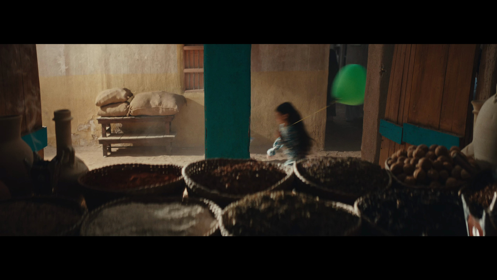 a woman standing in a room filled with lots of baskets