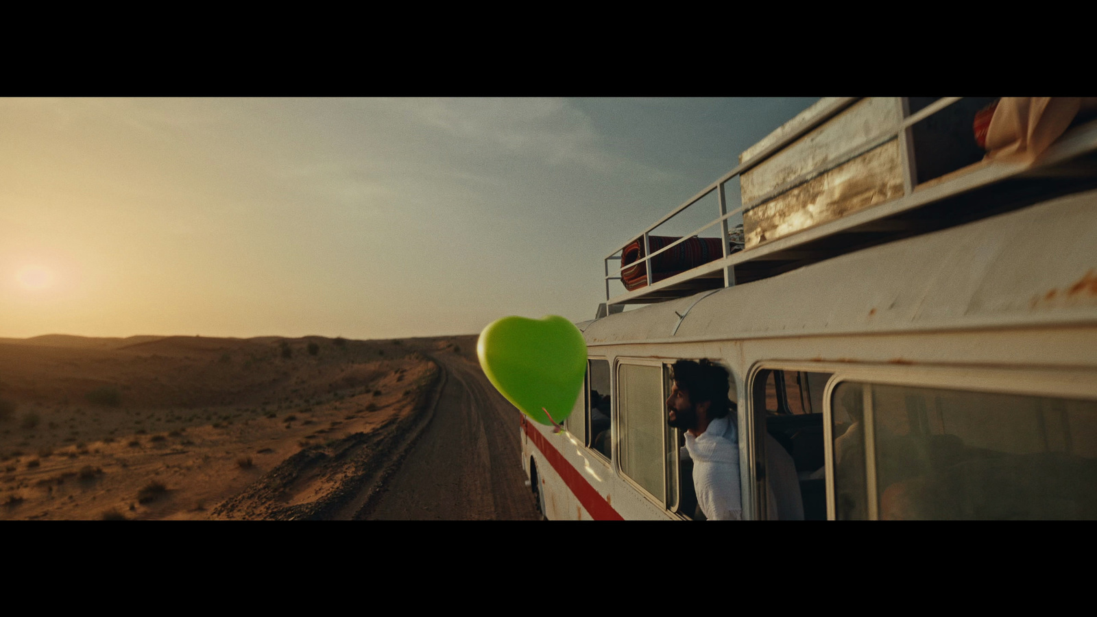 a woman standing on the side of a boat in the desert