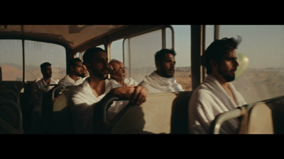 a group of men riding on the back of a bus