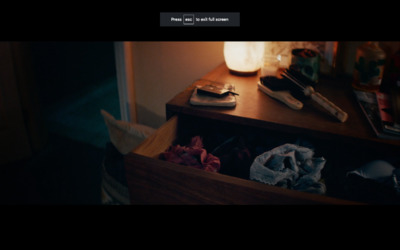 a wooden dresser with a drawer full of clothes