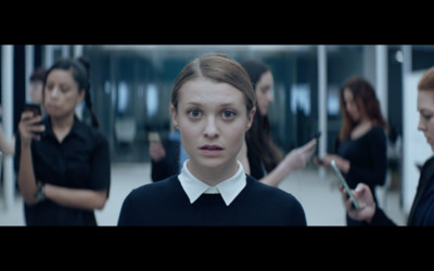 a woman in a black shirt and white collared shirt