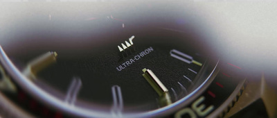 a close up of a watch face with a blurry background