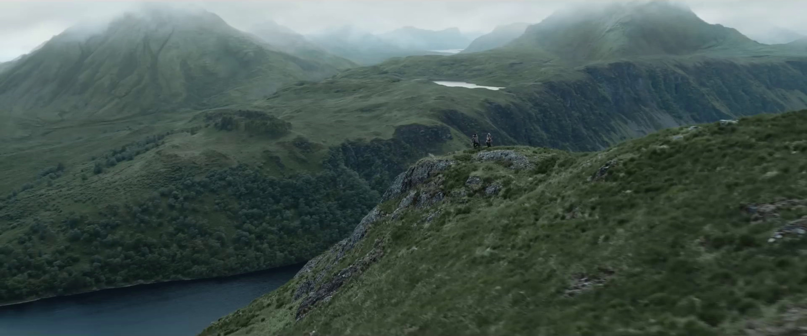 a mountain range with a body of water in the foreground