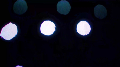 a close up of a traffic light with four different colored lights