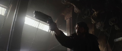 a man holding a gun in a dark room