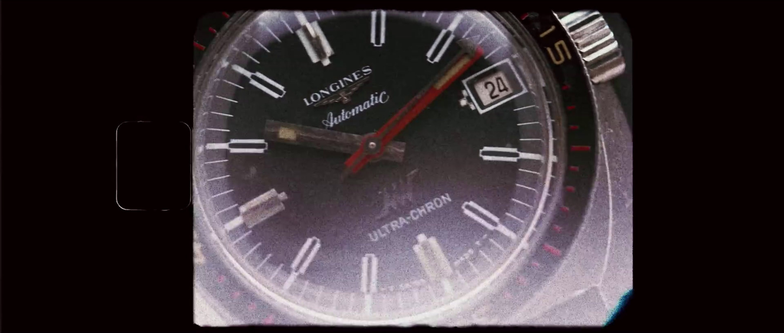 a close up of a watch with a red second hand