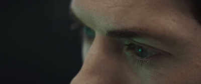 a close up of a person's face with green eyes