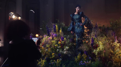 a woman standing in a field of flowers