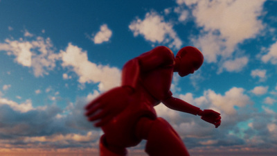 a red figure is standing in front of a cloudy sky