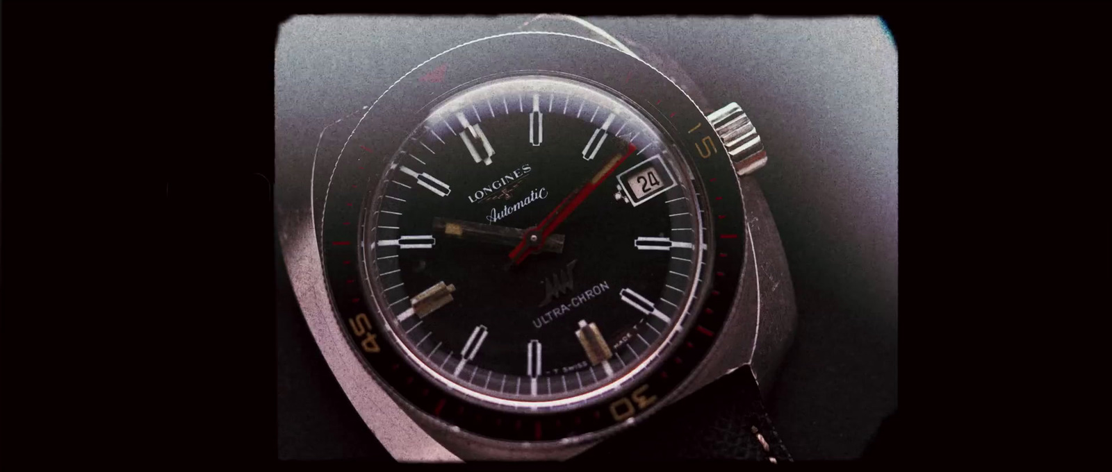 a close up of a watch on a black background