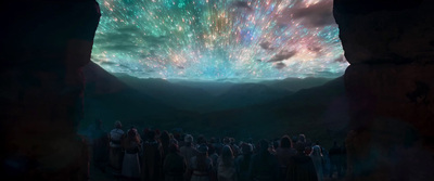 a group of people standing under a colorful sky filled with stars