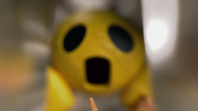 a person holding a yellow object with a surprised look on their face