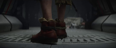 a close up of a person's feet wearing red boots