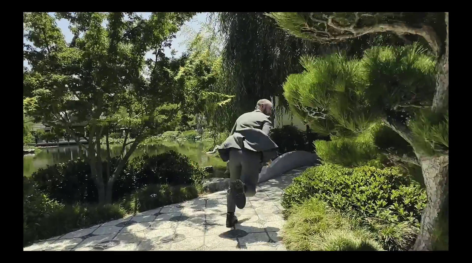 a man walking down a path in a park