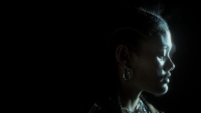 a woman in a dark room with a black background