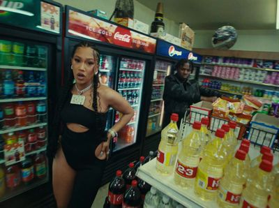 a woman standing in front of a display of drinks