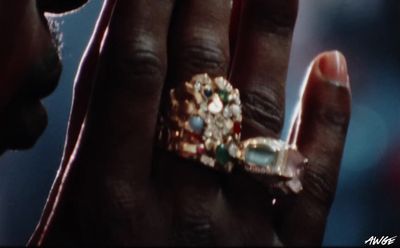 a close up of a person holding a ring