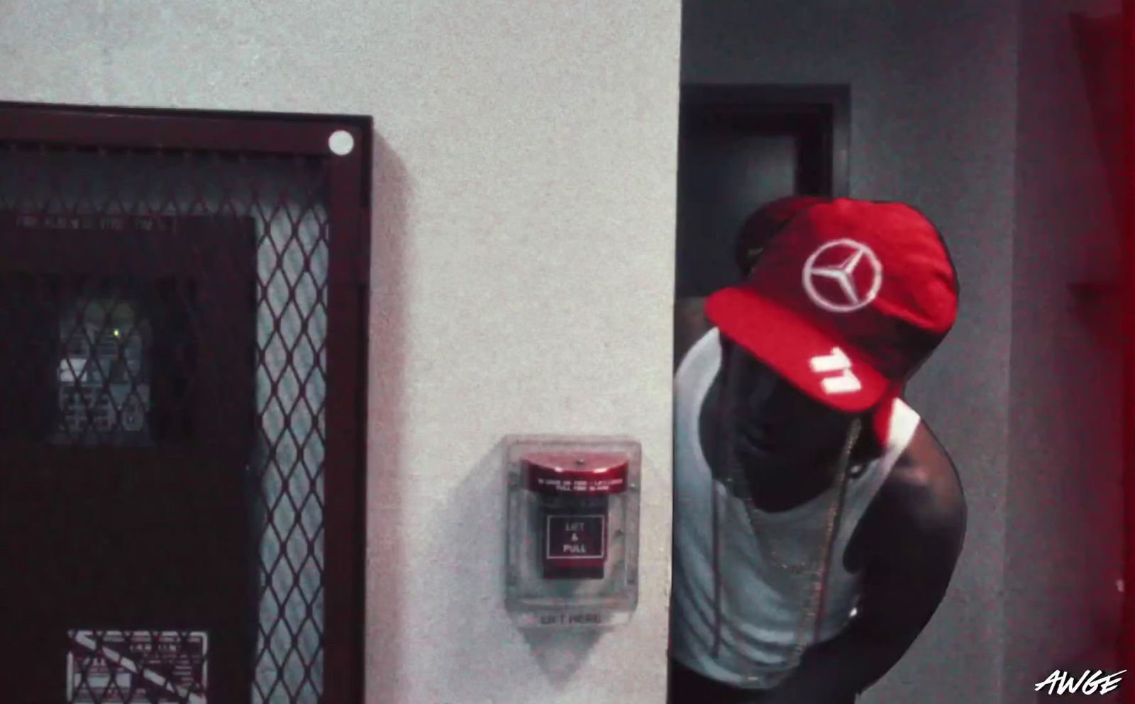 a man wearing a red hat standing next to a door