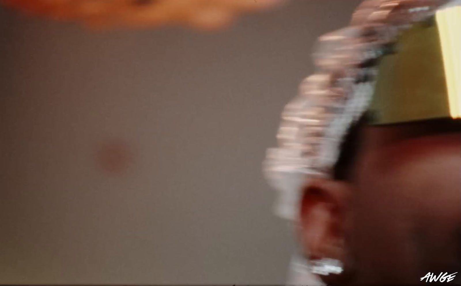 a man wearing a paper hat with donuts in the background