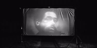 a black and white photo of a man's face on a screen