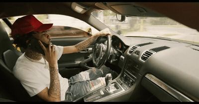 a man driving a car while talking on a cell phone