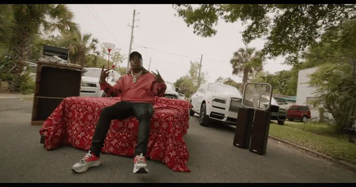 a man sitting on top of a red couch