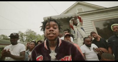 a group of people standing in front of a house