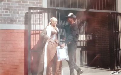 a man and a woman walking out of a jail cell