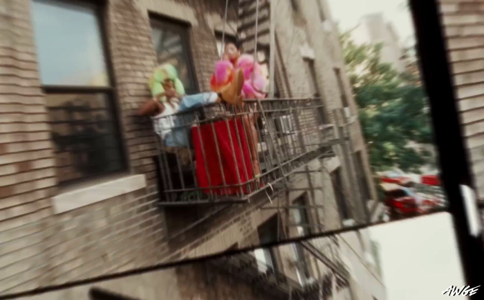 a group of people hanging out of a balcony