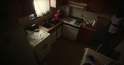 a kitchen with a sink, stove and a window