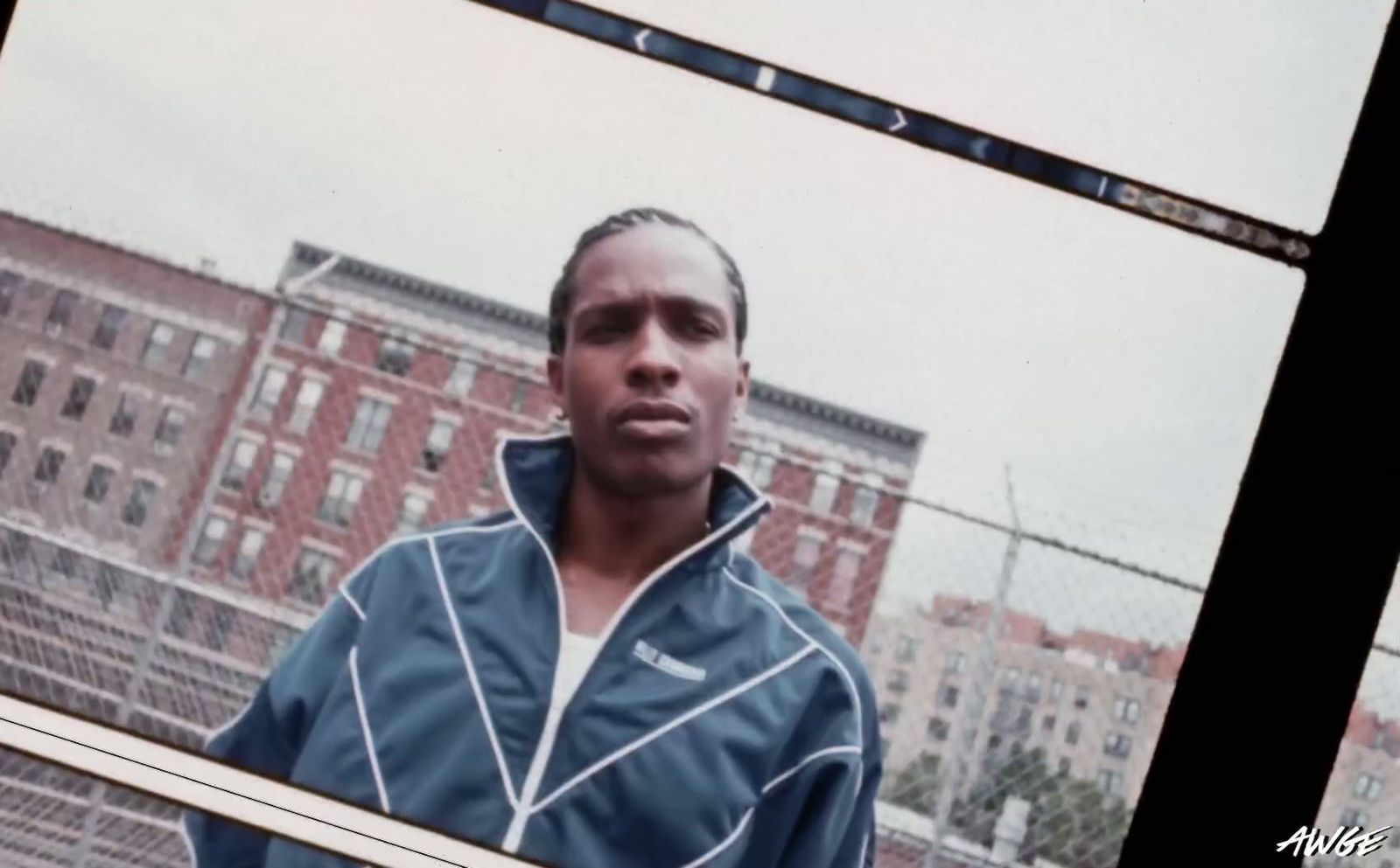 a man standing in front of a fence