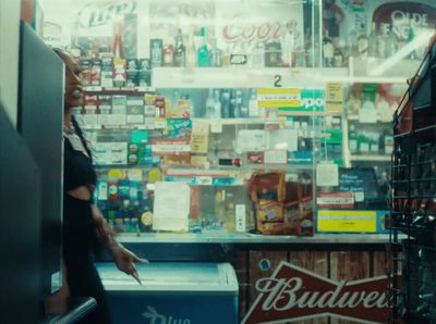 a woman standing in front of a budweiser store