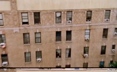 a tall building with lots of windows next to a street