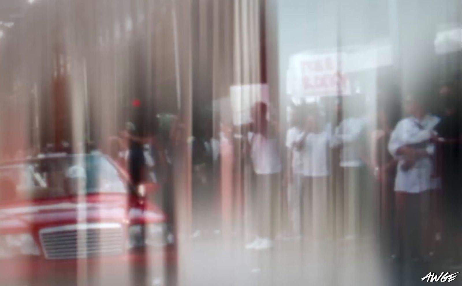 a blurry photo of a red car parked in front of a building