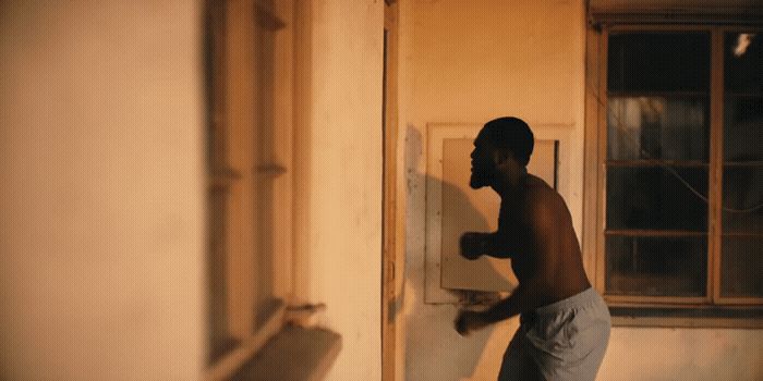 a young man standing in front of a door