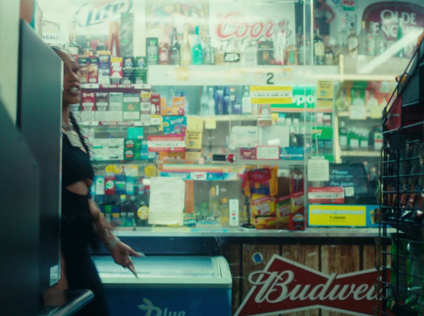 a woman standing in front of a budweiser store